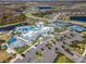 An aerial view of a luxurious community clubhouse featuring multiple pools, tennis courts, and ample parking at 18933 Sailors Delight Pass, Land O Lakes, FL 34638