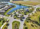 Aerial view of the community entrance with beautiful landscaping and a water feature, establishing an elegant arrival experience at 18933 Sailors Delight Pass, Land O Lakes, FL 34638