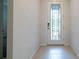 Bright entryway featuring a decorative glass front door and neutral tile flooring at 18933 Sailors Delight Pass, Land O Lakes, FL 34638