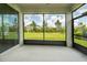 The screened-in lanai overlooks a lush, green lawn with mature trees and shrubs at 18933 Sailors Delight Pass, Land O Lakes, FL 34638