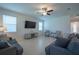 Bright, open living area with tile floors, neutral decor, and large windows for natural light at 18933 Sailors Delight Pass, Land O Lakes, FL 34638