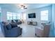 Spacious living room featuring tile flooring, plush seating, and large windows for natural light at 18933 Sailors Delight Pass, Land O Lakes, FL 34638