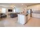 Open concept kitchen and living room with tile flooring and stainless steel appliances at 18933 Sailors Delight Pass, Land O Lakes, FL 34638