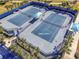 Aerial view of the community tennis courts, featuring a blue playing surface at 18933 Sailors Delight Pass, Land O Lakes, FL 34638