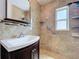 Updated bathroom featuring a decorative mirror, tiled walls, and a step-in shower at 2152 74Th N St, St Petersburg, FL 33710