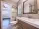 Updated bathroom featuring a modern vanity, decorative mirror, and tiled walls at 2152 74Th N St, St Petersburg, FL 33710