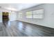 Bright living room featuring sleek gray wood floors, white walls, and large windows at 2152 74Th N St, St Petersburg, FL 33710