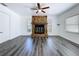 Spacious living room with a stone fireplace, wood flooring, ample natural light, and neutral tones at 2152 74Th N St, St Petersburg, FL 33710