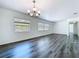 Spacious living room showcasing new wood floors, white walls, and natural light from large windows at 2152 74Th N St, St Petersburg, FL 33710