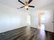 Bedroom featuring wood-look floors, a ceiling fan, and an ensuite bathroom at 2152 74Th N St, St Petersburg, FL 33710