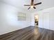 Bedroom featuring wood-look floors, a ceiling fan and an ensuite bathroom at 2152 74Th N St, St Petersburg, FL 33710