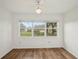 Bright bedroom featuring hardwood floors and a view to the exterior at 2436 Nantucket Harbor Loop # 104, Sun City Center, FL 33573