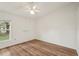 Spacious bedroom featuring hardwood floors, ample lighting, and closet at 2436 Nantucket Harbor Loop # 104, Sun City Center, FL 33573