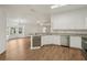 Open kitchen view with white cabinets, stainless steel appliances, and view of living area at 2436 Nantucket Harbor Loop # 104, Sun City Center, FL 33573