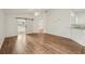 Open-concept living room features ceiling fan, barn door and opens to other areas of the home at 2436 Nantucket Harbor Loop # 104, Sun City Center, FL 33573