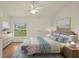 Well-lit primary bedroom with a decorative rug, ceiling fan, and a view to the exterior at 2436 Nantucket Harbor Loop # 104, Sun City Center, FL 33573