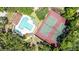 Overhead view of pool, tennis courts, trees and clubhouse at 2626 2Nd Ct, Palm Harbor, FL 34684