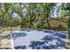 Outdoor basketball court surrounded by mature trees and fencing at 2626 2Nd Ct, Palm Harbor, FL 34684