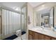 Bathroom view showing the toilet, shower, and the mirror reflecting the hallway at 2626 2Nd Ct, Palm Harbor, FL 34684