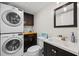 Bathroom with stacked washer and dryer and modern fixtures at 2626 2Nd Ct, Palm Harbor, FL 34684