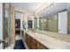 This bathroom features a granite countertop, shower, and multiple mirrors at 2626 2Nd Ct, Palm Harbor, FL 34684