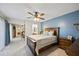 Main bedroom featuring a ceiling fan, carpeted floors, and an ensuite bathroom at 2626 2Nd Ct, Palm Harbor, FL 34684