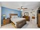 This main bedroom features a wood bedroom set, fan, and a door to the en suite bathroom at 2626 2Nd Ct, Palm Harbor, FL 34684