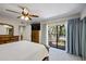 Carpeted main bedroom with ensuite bathroom, walk-in closet, and large sliding glass door at 2626 2Nd Ct, Palm Harbor, FL 34684