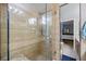 This shower features a glass door, tiled walls, and a shower head at 2626 2Nd Ct, Palm Harbor, FL 34684