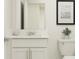 Modern bathroom with white cabinetry, quartz countertop, and decorative wall art at 2685 Buttercup Lucine Ln, Ruskin, FL 33570