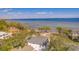 An aerial view showcasing the coastal location of the property, with a pier and ocean views at 2802 Northpointe Ln, Tampa, FL 33611