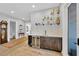 Interior bar area featuring a wine cooler, countertop, and decorative shelving at 2802 Northpointe Ln, Tampa, FL 33611