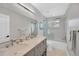 Bright bathroom features double sinks, marble countertop, and shower/tub combo at 2802 Northpointe Ln, Tampa, FL 33611