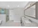 Bright bathroom featuring a double vanity, modern fixtures, and a glass-enclosed shower at 2802 Northpointe Ln, Tampa, FL 33611
