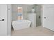 Contemporary bathroom showcasing a luxurious standalone tub and glass-enclosed shower at 2802 Northpointe Ln, Tampa, FL 33611