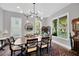 Elegant dining room with contemporary lighting, large windows, and seating for six at 2802 Northpointe Ln, Tampa, FL 33611