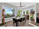 Bright dining room featuring a dark wood table, leather chairs, and large windows with water views at 2802 Northpointe Ln, Tampa, FL 33611