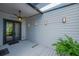 Stylish entrance to the home with double glass doors, modern sconces, and covered porch at 2802 Northpointe Ln, Tampa, FL 33611