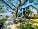Charming two-story home with landscaped front yard and mature trees, near water at 2802 Northpointe Ln, Tampa, FL 33611