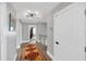 Hallway with hardwood floors, glass railing, modern lighting, and neutral paint at 2802 Northpointe Ln, Tampa, FL 33611