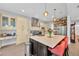 Open kitchen with stainless steel appliances, island with seating, and built-in shelving at 2802 Northpointe Ln, Tampa, FL 33611