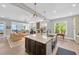Open-concept kitchen with large island, stainless steel sink, and view of the living area and waterfront at 2802 Northpointe Ln, Tampa, FL 33611
