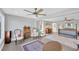Spacious main bedroom with ceiling fan, hardwood floors, sitting area, and a four-poster bed at 2802 Northpointe Ln, Tampa, FL 33611