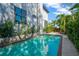A backyard pool with a brick-trimmed edge, surrounded by tropical landscaping at 2802 Northpointe Ln, Tampa, FL 33611
