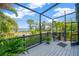 Screened porch with waterfront view offers outdoor living space with seating and pleasant scenery at 2802 Northpointe Ln, Tampa, FL 33611