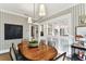 Dining room with wood table, patterned wallpaper and open to the kitchen at 2911 W Estrella St, Tampa, FL 33629