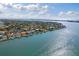 Waterfront home situated on a gorgeous street lined with mature landscaping and private boat docks at 297 1St W St, Tierra Verde, FL 33715