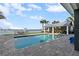 Swimming pool with outdoor kitchen, bar, and waterfront views at 297 1St W St, Tierra Verde, FL 33715