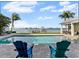 Backyard oasis with swimming pool, waterfront view, and lounge chairs at 297 1St W St, Tierra Verde, FL 33715