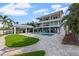 Stunning backyard features a swimming pool, a covered outdoor kitchen and well manicured landscaping at 297 1St W St, Tierra Verde, FL 33715